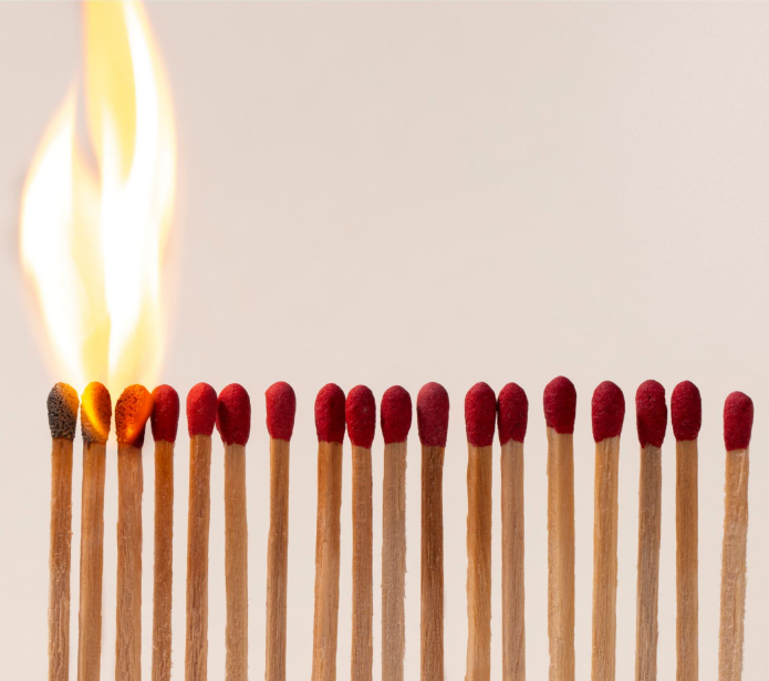 Matches lined up of which the first ones are burning